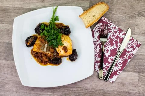Composition at the table of a plate of sweet and sour cod Stock Photos
