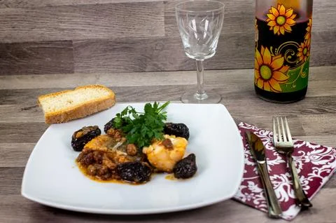 Composition at the table of a plate of sweet and sour cod Stock Photos