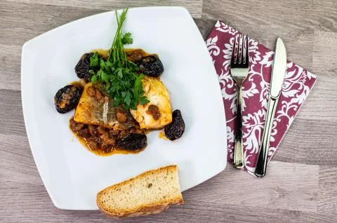 Composition at the table of a plate of sweet and sour cod Stock Photos