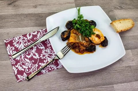 Composition at the table of a plate of sweet and sour cod Stock Photos