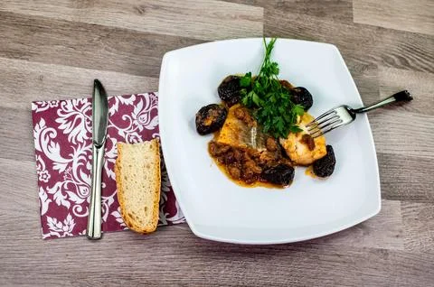 Composition at the table of a plate of sweet and sour cod Stock Photos