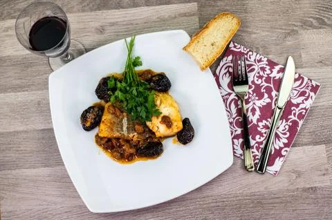 Composition at the table of a plate of sweet and sour cod Stock Photos