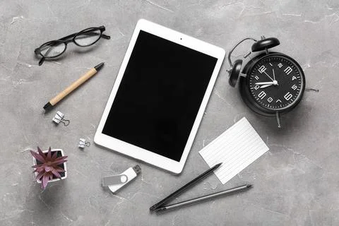 Composition with tablet computer, alarm clock, stationery and modern flash dr Stock Photos