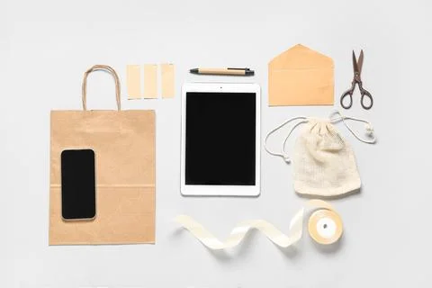 Composition with tablet computer, mobile phone and delivery paper bag on grey Stock Photos