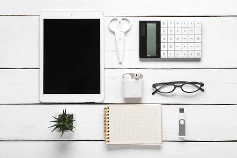 Composition with tablet computer, stationery and modern flash drive on white  Stock Photos