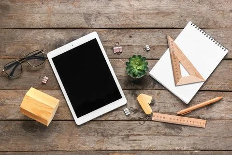 Composition with tablet computer, stationery and modern flash drive on wooden Stock Photos