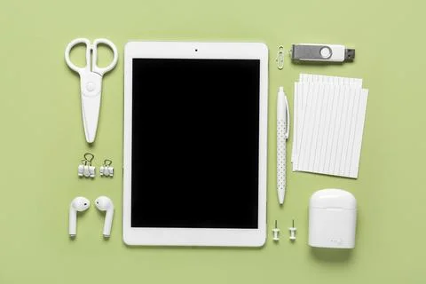 Composition with tablet computer, stationery and modern flash drive on green  Stock Photos