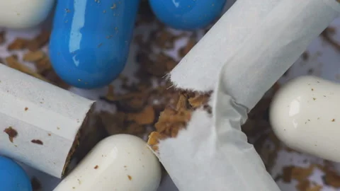 Composition of tablets and torn cigarettes with tobacco rotating Video stock 88093917