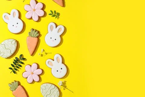 Composition with tasty Easter cookies and flowers on yellow background Stock Photos
