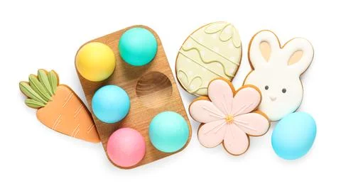 Composition with tasty Easter cookies and eggs isolated on white background Stock Photos