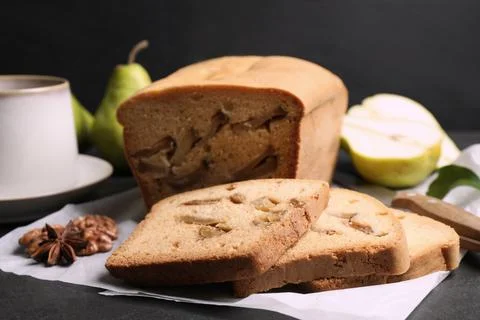 Composition with tasty pear bread on black slate table, closeup. Homemade cak Stock Photos