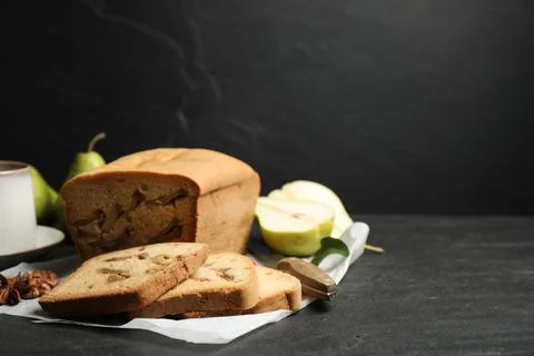 Composition with tasty pear bread on black slate table, space for text. Homem Stock Photos