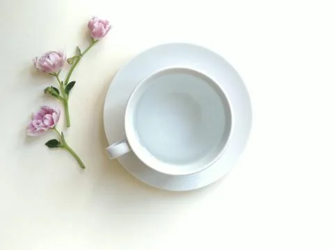 Composition with tea coffee and a couple of three flowers Stock Photos