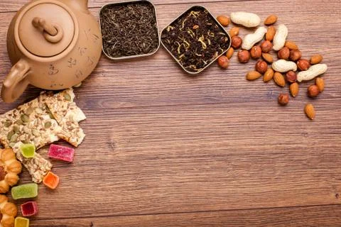 The composition of the tea on a wooden surface. brown teapot from clay with.. Stock Photos