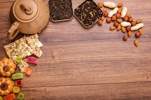The composition of the tea on a wooden surface. brown teapot from clay with.. Stock Photos