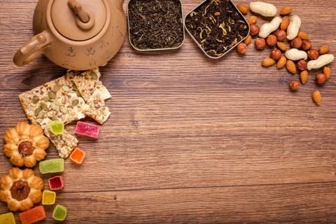 The composition of the tea on a wooden surface. brown teapot from clay with.. Stock Photos