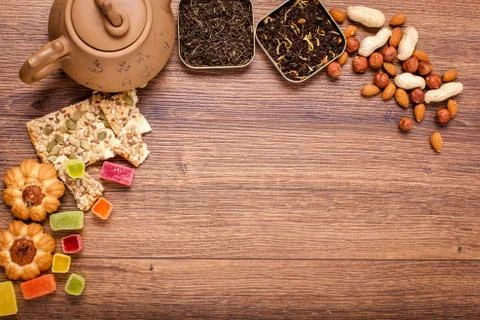 The composition of the tea on a wooden surface. brown teapot from clay with.. Stock Photos