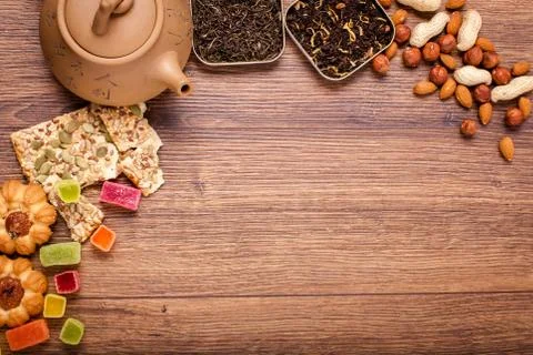 The composition of the tea on a wooden surface. brown teapot from clay with.. Stock Photos