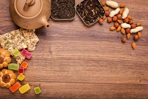 The composition of the tea on a wooden surface. brown teapot from clay with.. Stock Photos