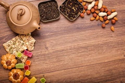 The composition of the tea on a wooden surface. brown teapot from clay with.. Stock Photos