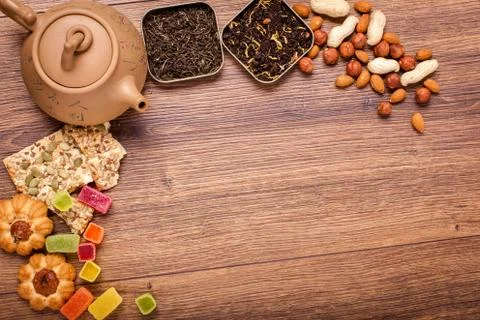 The composition of the tea on a wooden surface. brown teapot from clay with.. Stock Photos