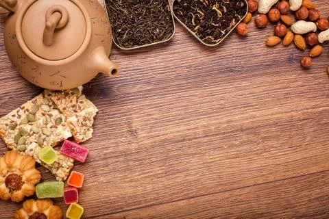 The composition of the tea on a wooden surface. brown teapot from clay with.. Stock Photos
