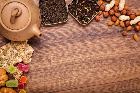 The composition of the tea on a wooden surface. brown teapot from clay with.. Stock Photos