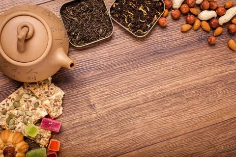 The composition of the tea on a wooden surface. brown teapot from clay with.. Stock Photos