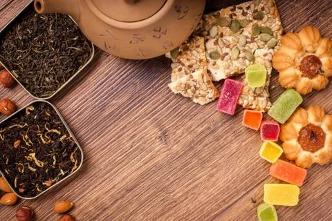 The composition of the tea on a wooden surface. brown teapot from clay with.. Stock Photos