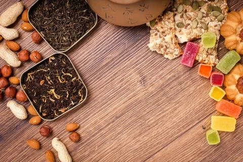 The composition of the tea on a wooden surface. brown teapot from clay with.. Stock Photos