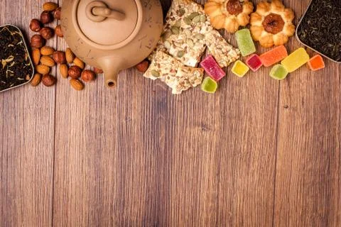 The composition of the tea on a wooden surface. brown teapot from clay with.. Stock-Fotos