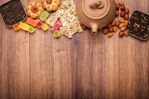 The composition of the tea on a wooden surface. brown teapot from clay with.. Stock Photos