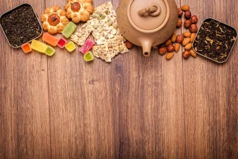 The composition of the tea on a wooden surface. brown teapot from clay with.. Stock Photos