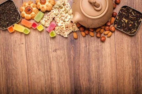 The composition of the tea on a wooden surface. brown teapot from clay with.. Stock Photos