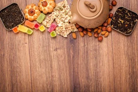 The composition of the tea on a wooden surface. brown teapot from clay with.. Stock Photos