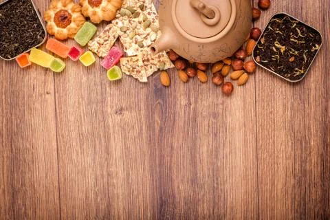 The composition of the tea on a wooden surface. brown teapot from clay with.. Stock Photos