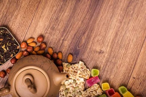The composition of the tea on a wooden surface. brown teapot from clay with.. Stock Photos