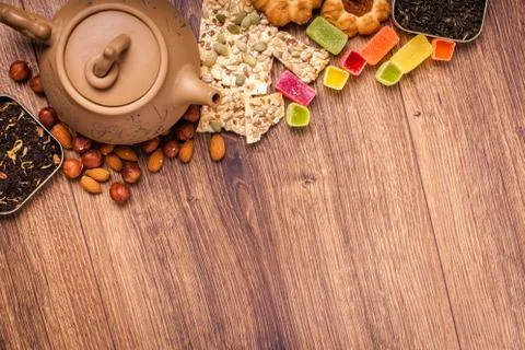 The composition of the tea on a wooden surface. brown teapot from clay with.. Stock Photos