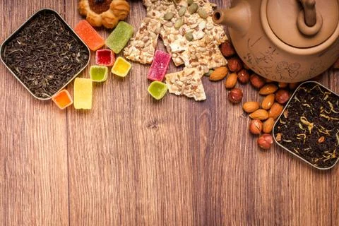 The composition of the tea on a wooden surface. brown teapot from clay with.. Stock-Fotos