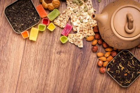 The composition of the tea on a wooden surface. brown teapot from clay with.. Stock Photos