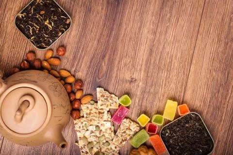 The composition of the tea on a wooden surface. brown teapot from clay with.. Stock Photos