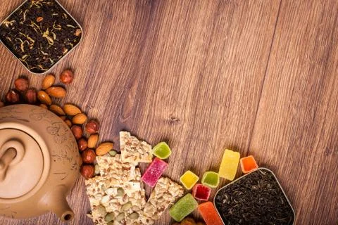 The composition of the tea on a wooden surface. brown teapot from clay with.. Stock Photos