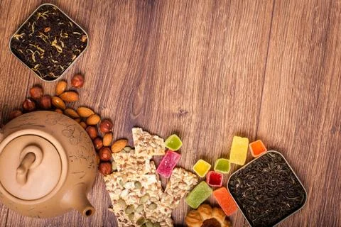 The composition of the tea on a wooden surface. brown teapot from clay with.. Stock Photos