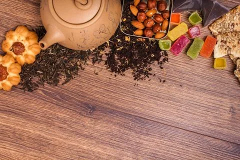The composition of the tea on a wooden surface. brown teapot from clay with.. Stock Photos