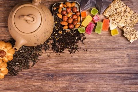 The composition of the tea on a wooden surface. brown teapot from clay with.. Stock-Fotos