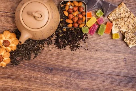 The composition of the tea on a wooden surface. brown teapot from clay with.. Stock Photos