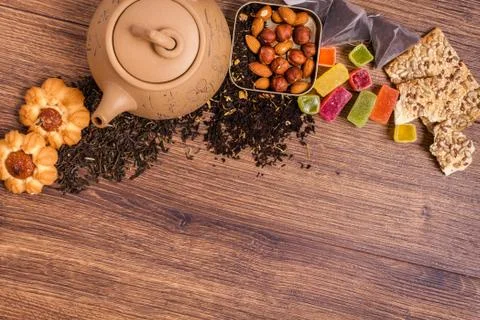The composition of the tea on a wooden surface. brown teapot from clay with.. Stock Photos