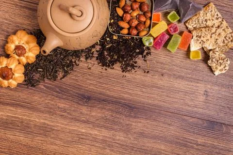The composition of the tea on a wooden surface. brown teapot from clay with.. Stock Photos