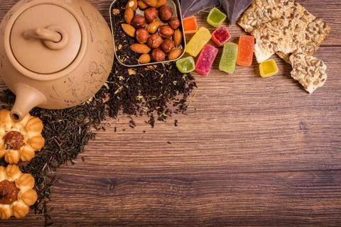 The composition of the tea on a wooden surface. brown teapot from clay with.. Stock Photos