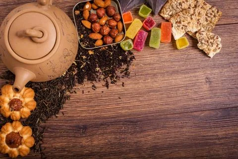 The composition of the tea on a wooden surface. brown teapot from clay with.. Stock Photos